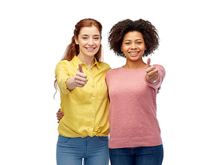 Image showing happy smiling women showing thumbs up