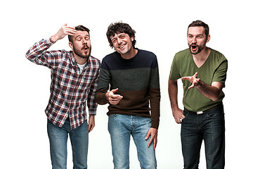 Image showing The three men are smiling, looking at camera