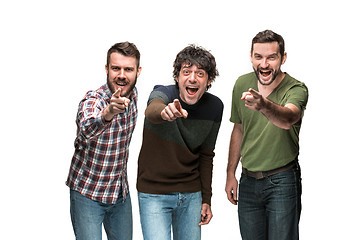 Image showing The three men are smiling, looking and pointing at camera