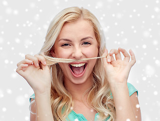 Image showing happy young woman making mustache with her hair