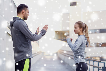 Image showing woman with coach working out strike outdoors