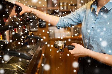 Image showing close up of woman making coffee by machine at cafe