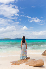 Image showing Woman enjoying Anse Patates picture perfect beach on La Digue Island, Seychelles.