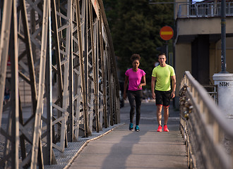 Image showing multiethnic couple jogging in the city