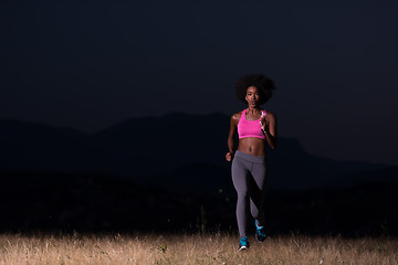 Image showing Young African american woman jogging in nature