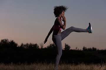 Image showing black woman is doing stretching exercise relaxing and warm up