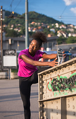 Image showing African American woman doing warming up and stretching