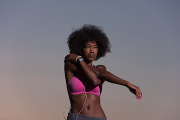 Image showing black woman is doing stretching exercise relaxing and warm up