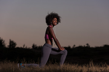 Image showing black woman is doing stretching exercise relaxing and warm up