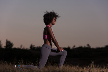 Image showing black woman is doing stretching exercise relaxing and warm up