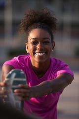 Image showing African American woman doing warming up and stretching