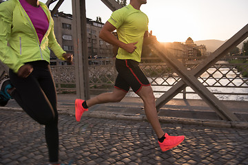 Image showing young multiethnic couple jogging in the city