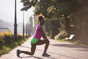 Image showing Black woman doing warming up and stretching