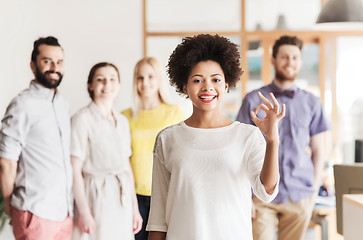 Image showing happy woman showing ok over creative office team