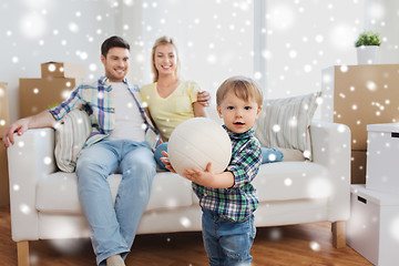 Image showing happy little boy with ball over parents at home