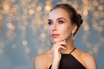 Image showing beautiful woman in black wearing diamond jewelry