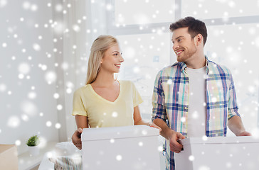 Image showing smiling couple with big boxes moving to new home