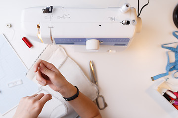 Image showing Dressmaker with sewing-machine top view