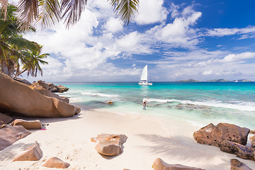 Image showing Woman enjoying Anse Patates picture perfect beach on La Digue Island, Seychelles.