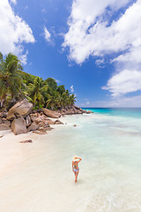 Image showing Woman enjoying Anse Patates picture perfect beach on La Digue Island, Seychelles.