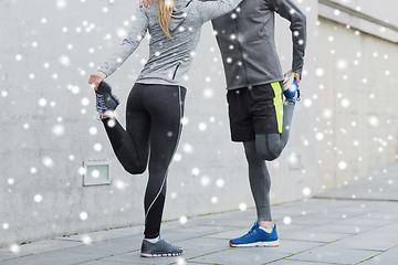 Image showing close up of couple stretching legs outdoors