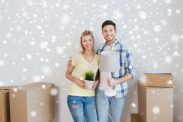 Image showing smiling couple with boxes moving to new home