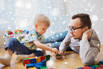 Image showing father and son playing with toy blocks at home