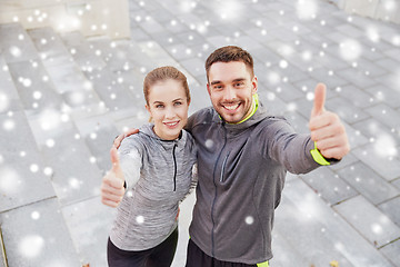 Image showing couple of sportsmen showing thumbs up outdoors