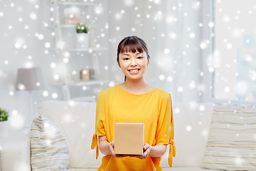 Image showing happy asian young woman with parcel box at home