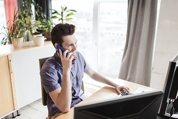 Image showing happy creative male worker calling on smarphone