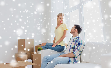 Image showing happy couple with cardboard boxes at new home