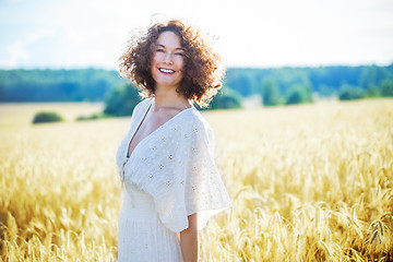 Image showing beautiful woman in a white dress in a wheat field