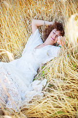 Image showing happy sleeping woman in wheat field