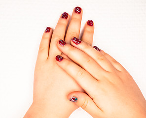 Image showing Little girl with beautiful manicure in dark pink, towards white 