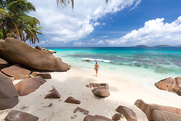 Image showing Woman enjoying Anse Patates picture perfect beach on La Digue Island, Seychelles.