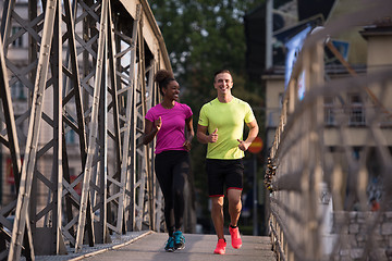 Image showing multiethnic couple jogging in the city