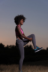 Image showing black woman is doing stretching exercise relaxing and warm up