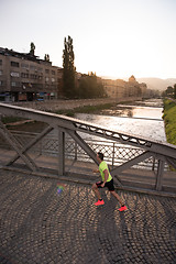 Image showing a young man jogging in the city