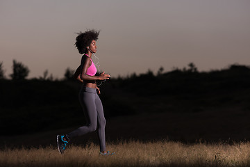 Image showing Young African american woman jogging in nature