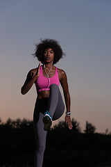 Image showing black woman is doing stretching exercise relaxing and warm up