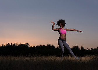 Image showing black woman is doing stretching exercise relaxing and warm up