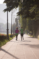 Image showing young multiethnic couple jogging in the city