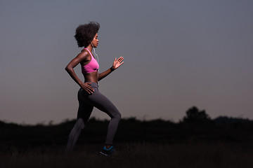 Image showing Young African american woman jogging in nature