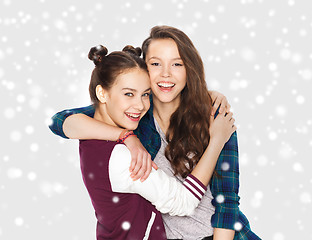 Image showing happy pretty teenage girls hugging over snow