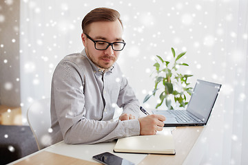 Image showing creative man or businessman writing to notebook