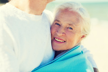 Image showing happy senior couple hugging on summer beach