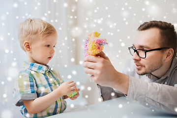 Image showing father and son playing with ball clay at home