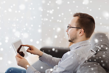 Image showing smiling man working with tablet pc at home