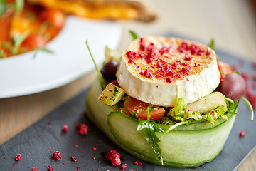 Image showing goat cheese salad with vegetables at restaurant