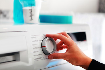 Image showing woman hand adjusting washing machine